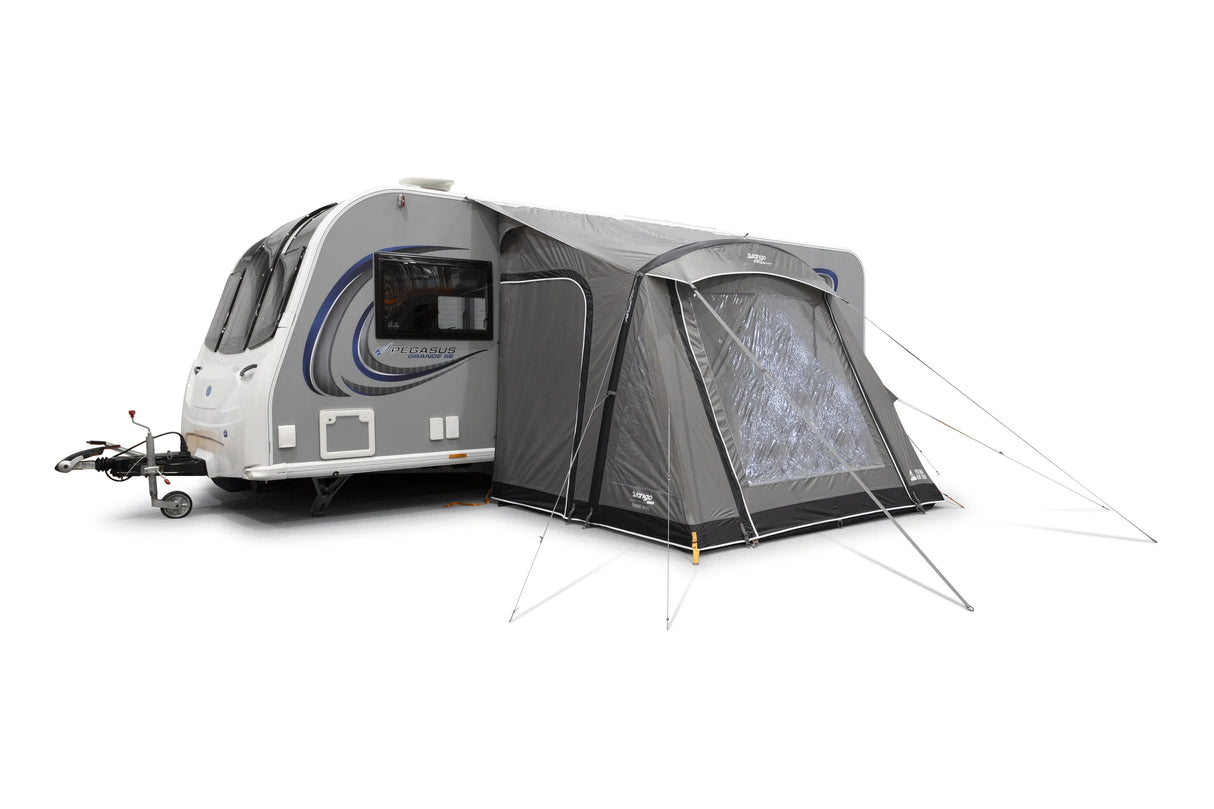 Caravan with an attached tent on a white background