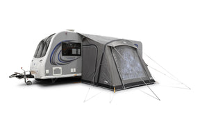 Caravan with an attached tent on a white background