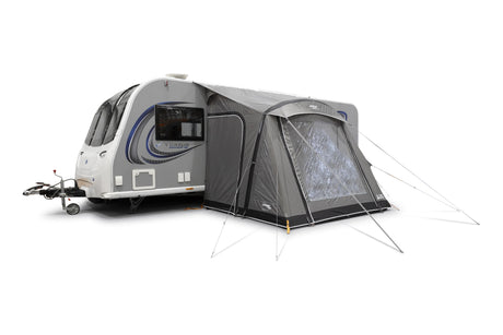 Caravan with an attached tent on a white background