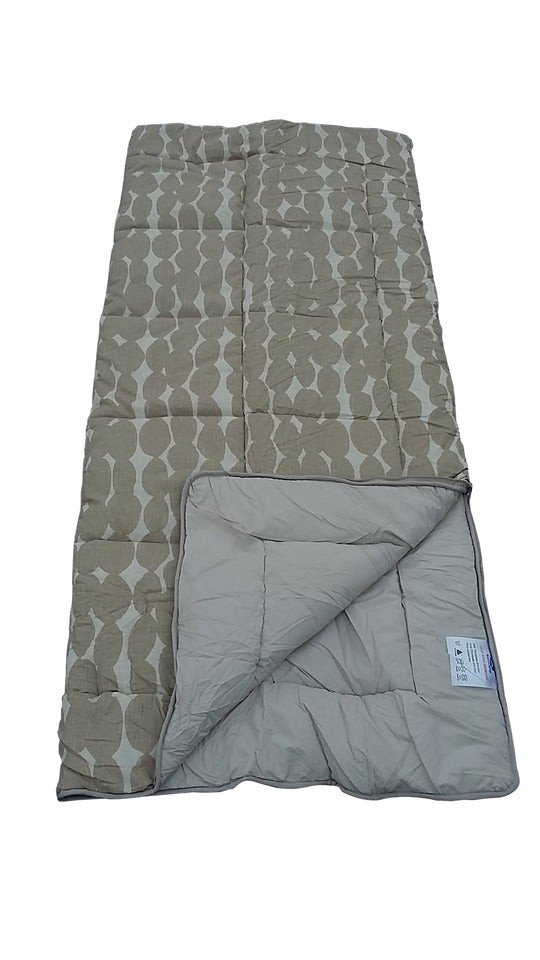 Folded quilt with geometric pattern on a white background